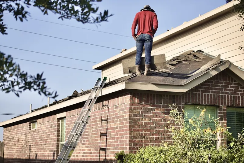 Professional roofer working on a residential roof in Laytonsville